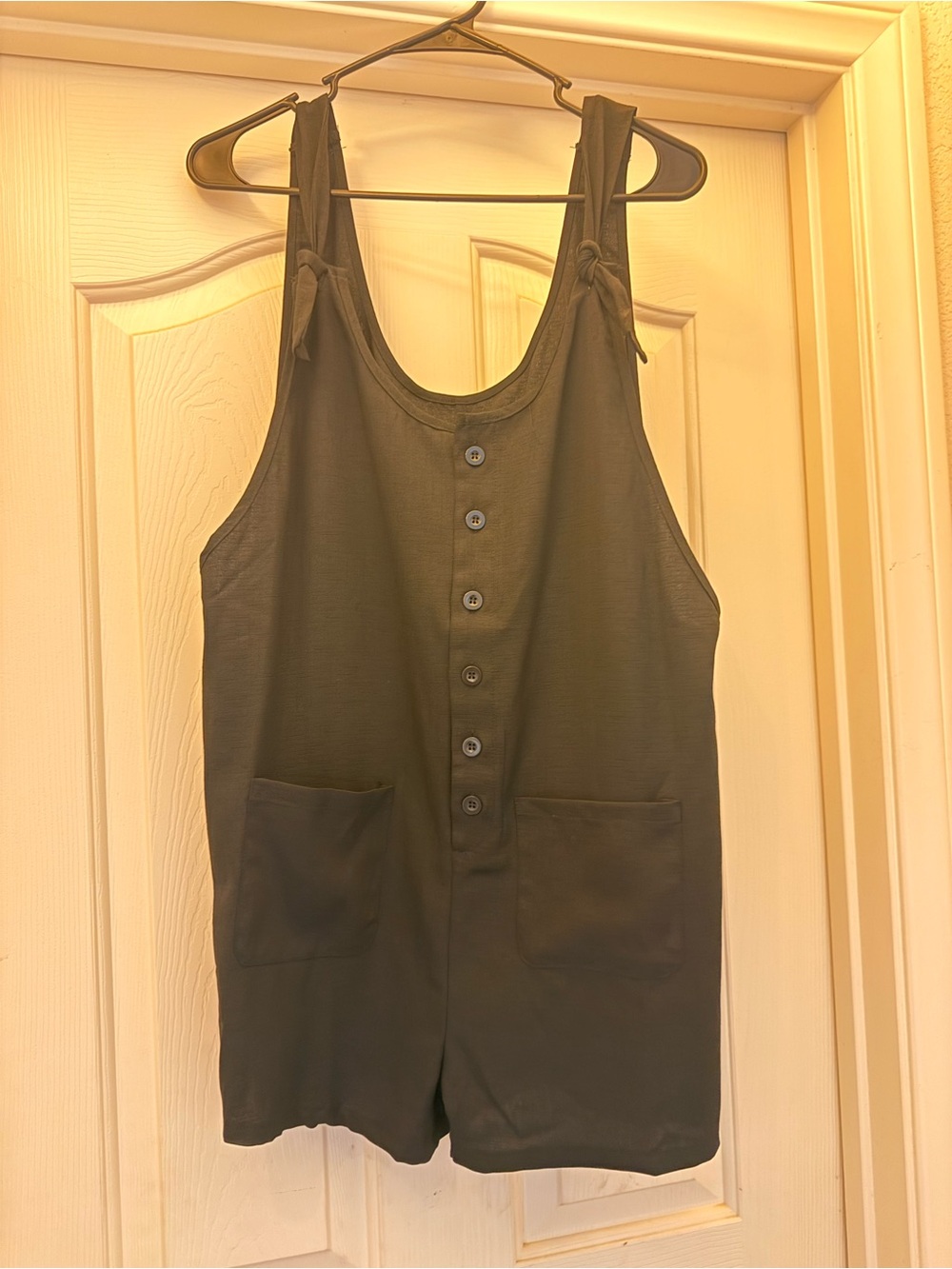 Womanโs black Button-Front One-Piece Romper